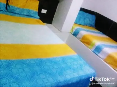a close up of a bed in a room at Hotel Minorista plaza in Medellín
