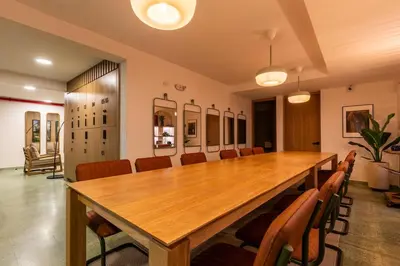 a conference room with a large wooden table and chairs at 103 Design Loft Escape Hammock AC & Great Vibes in Medellín