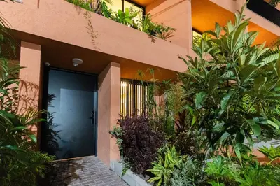 a front door of a house with plants at 201 Stylish Retreat in Laureles Area Terrace AC in Medellín