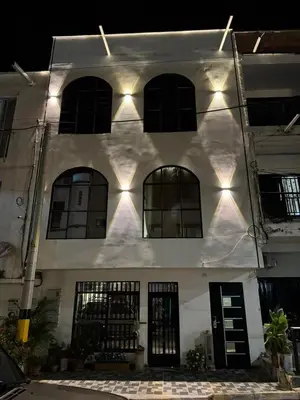 a white building with windows and lights on it at Habitaciones en Doradal 204 in Doradal