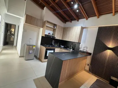 a kitchen with a black counter top in a room at Full apartment in Laureles in Medellín