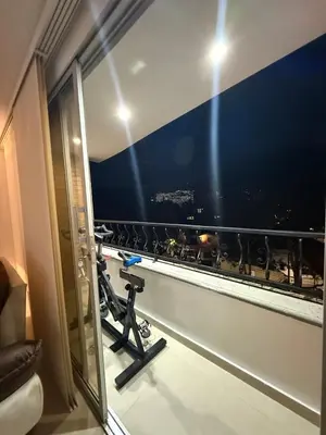 a room with a window with a view of a city at Refugio en laureles in Medellín