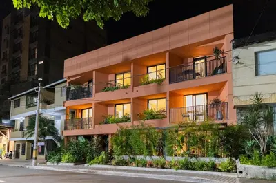 an apartment building on a city street at night at 202 Modern Stay in Laureles Area Cozy Balcony AC in Medellín
