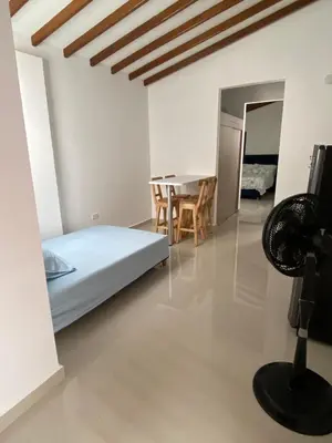a bedroom with a bed and a table and chairs at Las Flores de Mria 303 in Jardin