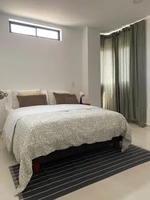 a white bedroom with a large bed and a window at Candilejas in Fredonia