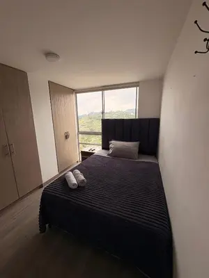 a bedroom with a bed with two shoes on it at Apartamento Urban Manizales Acogedor in Manizales