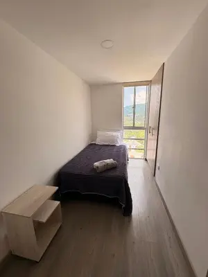 a bedroom with a bed and a large window at Apartamento Urban Manizales Acogedor in Manizales