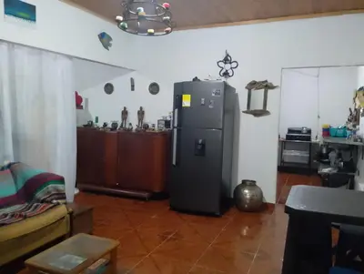 a kitchen with a refrigerator in a room at Casa Sol y Río in Honda