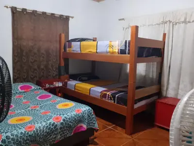 a bedroom with two bunk beds and a bed at Casa Sol y Río in Honda
