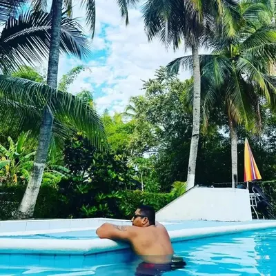 a man laying on a raft in a swimming pool at Siboney hotel in Honda