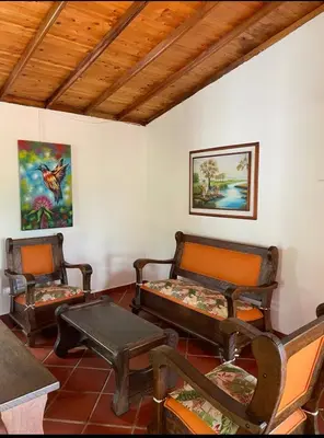 a room with two beds and a table and chairs at Ranch Style Home Jardin Del Eden in Verdún