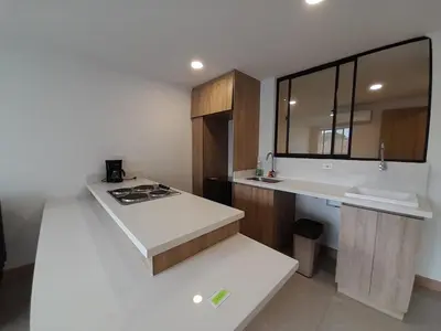 a white kitchen with a counter and a sink at MEDELLIN ALOJAMIENTO EN Laureles in Medellín