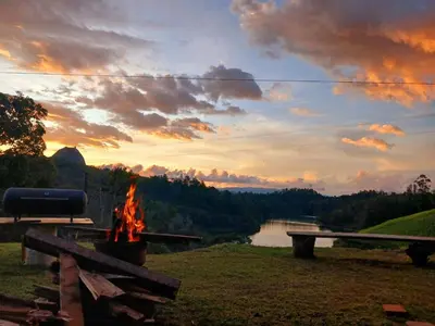 a fire pit with a view of a lake at Nakawe Guatape in Guatapé