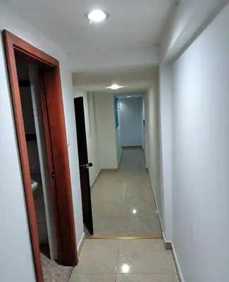 an empty hallway with a hallway leading to a room at Cómodo apartamento por días in Manizales