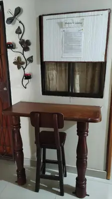 a wooden table with a chair and a microwave at Habitación central con cama doble #1 in Medellín