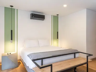 a bedroom with a bed and a bench in it at NOK Spectacular 3 BR w Balcony in Laureles Medellin in Medellín