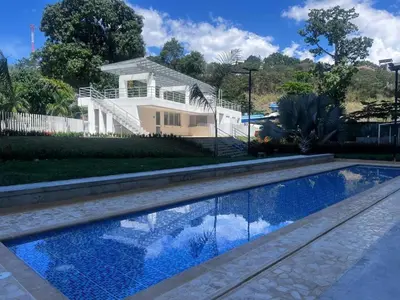 a house with a swimming pool in front of a house at Espectacular Apto Citadela Di Sole Santafe de Antioquia in Santa Fe de Antioquia