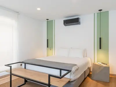 a bedroom with a bed and a bench in it at NOK Stylish 3BR in Laureles MDE in Medellín