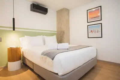 a bedroom with a large white bed in a room at NOK Perfect 3 BR in Laureles in Medellin in Medellín