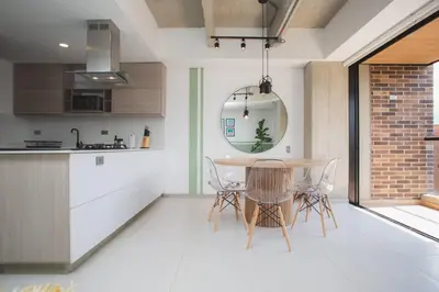 a kitchen and dining room with a table and chairs at NOK Perfect 3 BR in Laureles in Medellin in Medellín