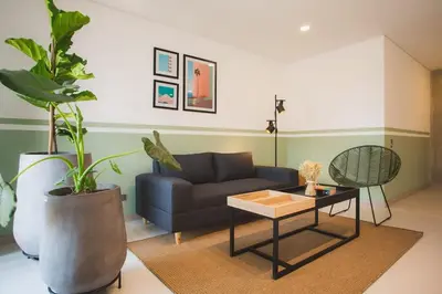 a living room with a couch and a table at NOK Cool 3 BR With Balcony in Laureles Medellin in Medellín