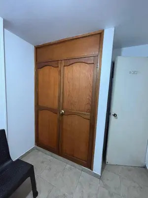 a wooden door in the corner of a room at Minca in Medellín