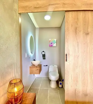 a bathroom with a toilet and a sink at San Telmo Guatape Apto con Jacuzzy in Guatapé