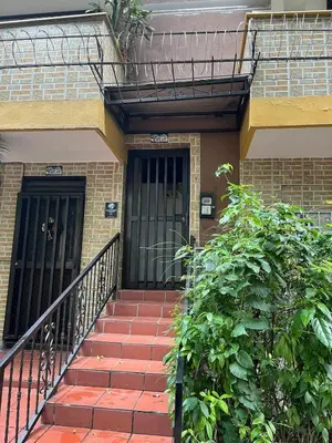 a staircase leading to a building with black doors at Spacious and bright in Medellín