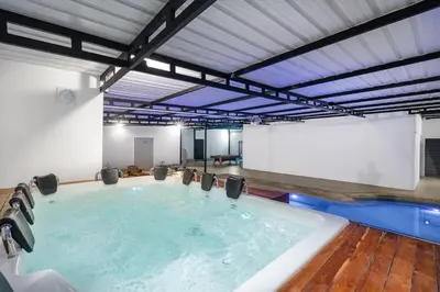 a large swimming pool with a large screen in a building at villa poblado in Medellín