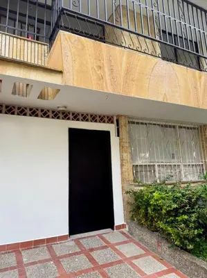 a black door on the side of a building at Alojamiento entero loft en Medellin, Estadio in Medellín