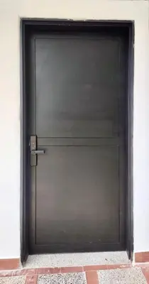 a large metal garage door in a building at Loft Medellin a Dos Calles del Estadio in Medellín