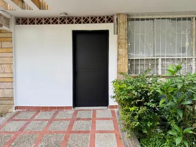 a black door on the side of a house at Loft Medellin a Dos Calles del Estadio in Medellín