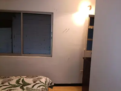 a bedroom with a window and a bed in it at Hostal Villa Café in Manizales