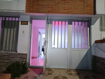 an open door to a building with pink lighting at Hostal Villa Café in Manizales