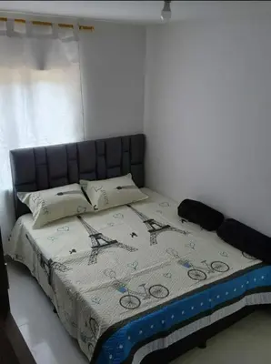 a bedroom with a bed with a quilt on it at Apartamento el descanso in Medellín