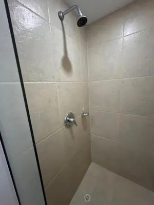 a shower with a glass door in a bathroom at Cómoda Habitación condominio, wifi, piscina in Medellín