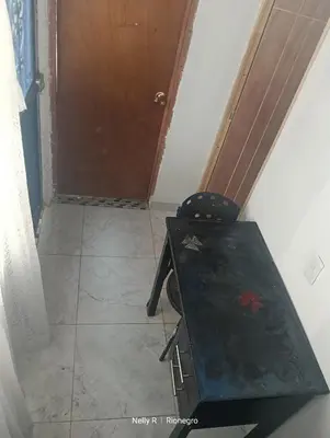 a room with a wooden table and a door at Alojamiento Ríonegro in Rionegro