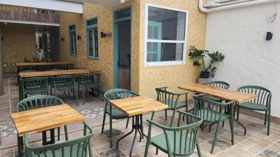 a row of tables and chairs at a restaurant at Hotel Boutique Paraíso Plaza Aguadas in Aguadas
