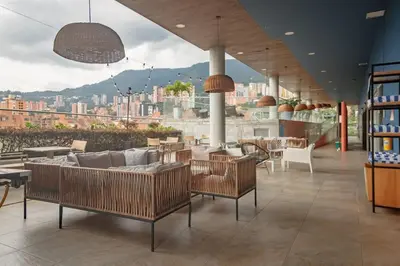 a restaurant with chairs and tables and a view of a city at Luxury Studio El Poblado City View 7th Floor in Medellín