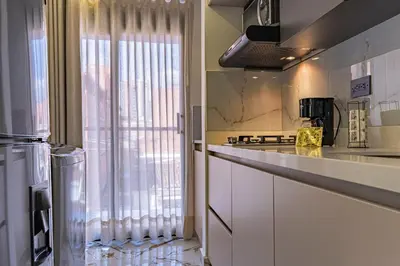 a kitchen with a counter and a sink and a window at loft 72 holiday inn medellin in Medellín