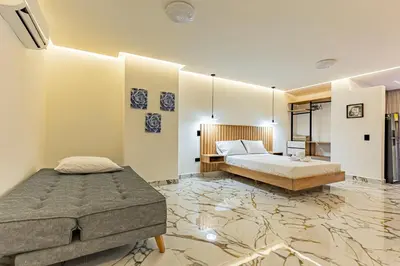 a bedroom with a king sized bed and a bathroom at Apartaloft exclusivo en laureles in Medellín