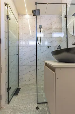 a bathroom with a glass shower and a sink at Apartaloft exclusivo en laureles in Medellín