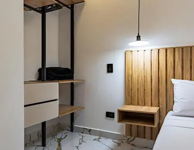 a bedroom with a bed and a wooden headboard at Exclusivo Urban Loft en Laureles in Medellín