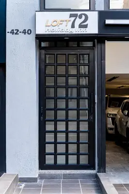 a black door with a sign on a building at Exclusivo Urban Loft en Laureles in Medellín