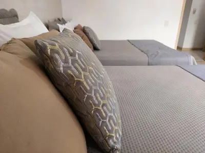 two beds with pillows on them in a bedroom at All Inclusive Suites in Medellín