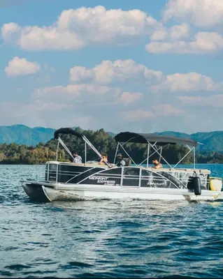 a group of people in a boat on the water at Luxé Cabañas in Guatapé