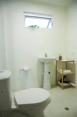 a bathroom with a white toilet and a sink at Home Aris Apartments 201 in Medellín