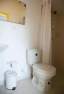 a bathroom with a white toilet and a shower at Apartamento remodelado en el mejor lugar del centro de Medellín. Home Aris 402 in Medellín