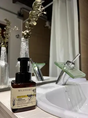 a bottle of mulleton moisturizing soap sitting on a bathroom sink at Compostela cabaña privada (private cabin for rent) in Jardin