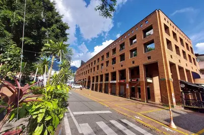 a large brick building on a city street at Apartamento en Parque del Poblado in Medellín